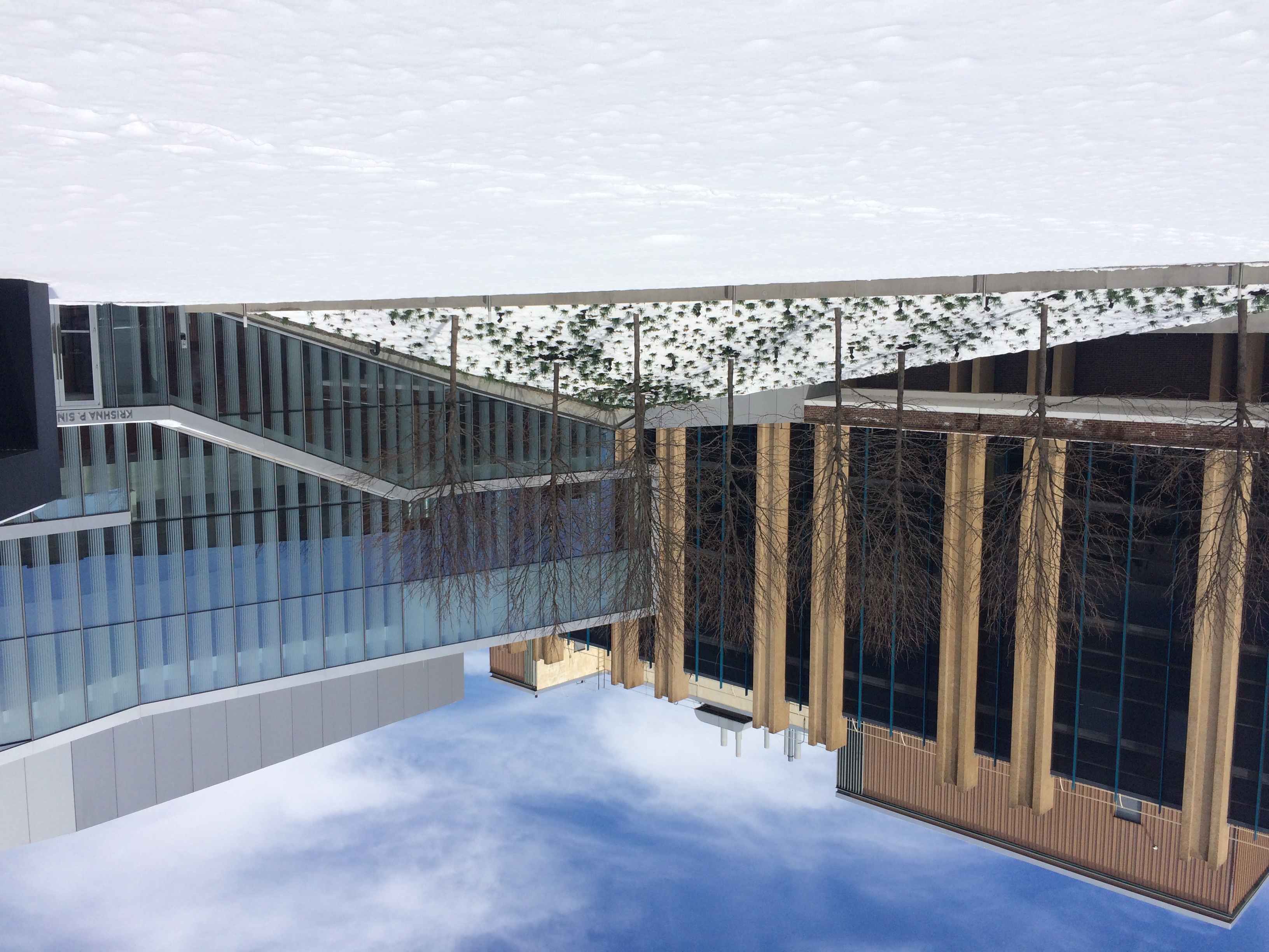 Image from Penn's campus showing two buildings, one from mid-century and the other more recent and made of glass and metal.